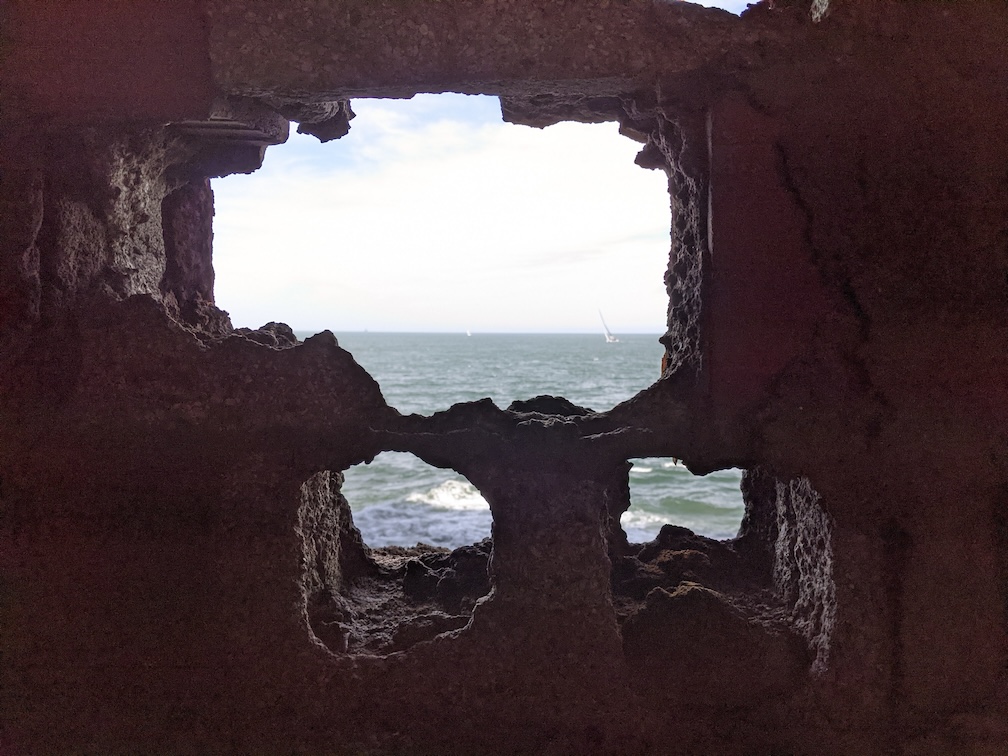 Seascape view framed by rocky formations, symbolizing the areas to navigating through challenges in toxic family dynamics, ADHD, anxiety, depression, and trauma